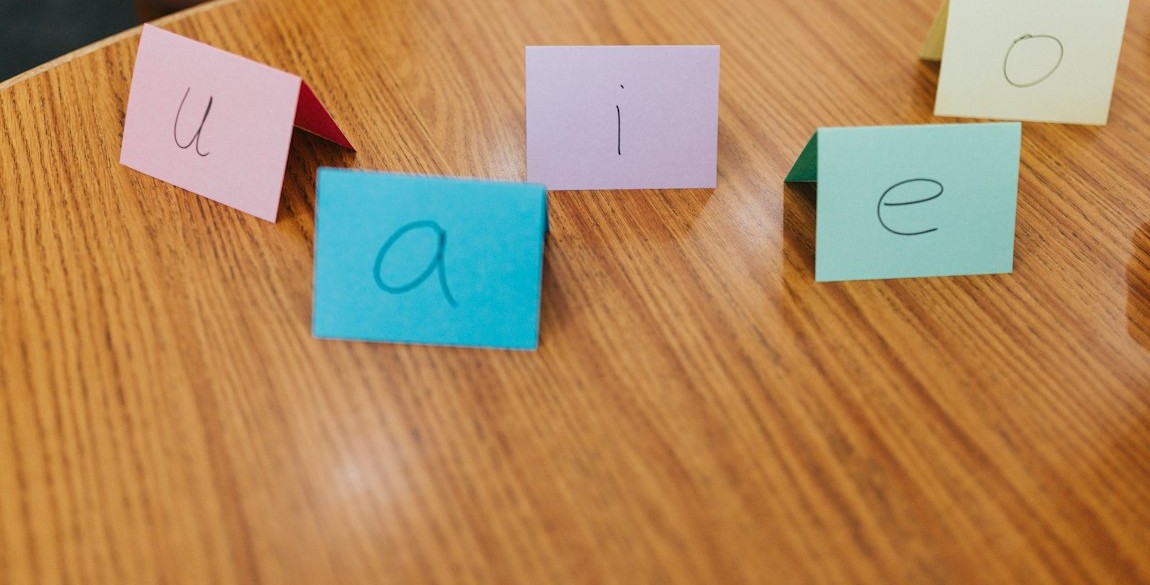 Folded paper cards with handwritten letters on a wooden table